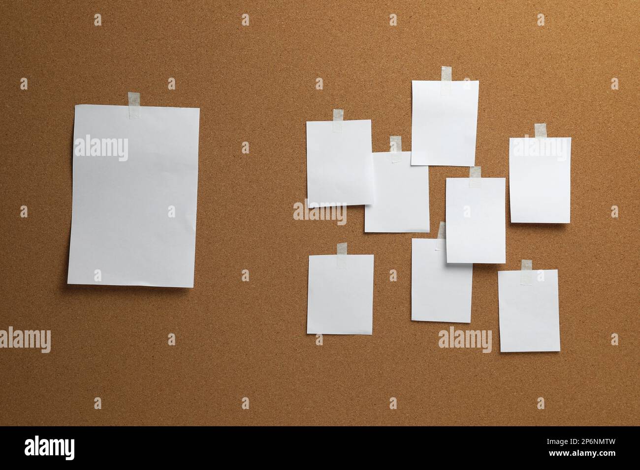 Blank white paper sheets on cork board Stock Photo