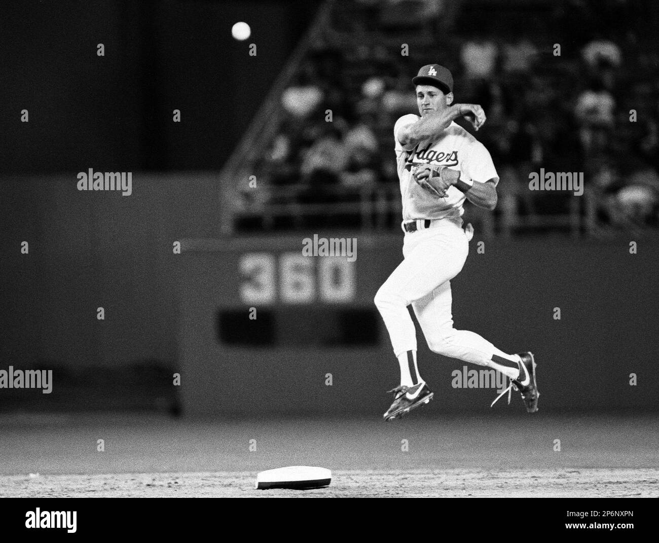 Steve Sax of the Los Angeles Dodgers relays a double play throw to