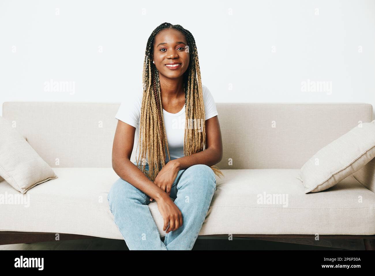 Happy african american woman sitting at home on sofa, rest and vacation ...