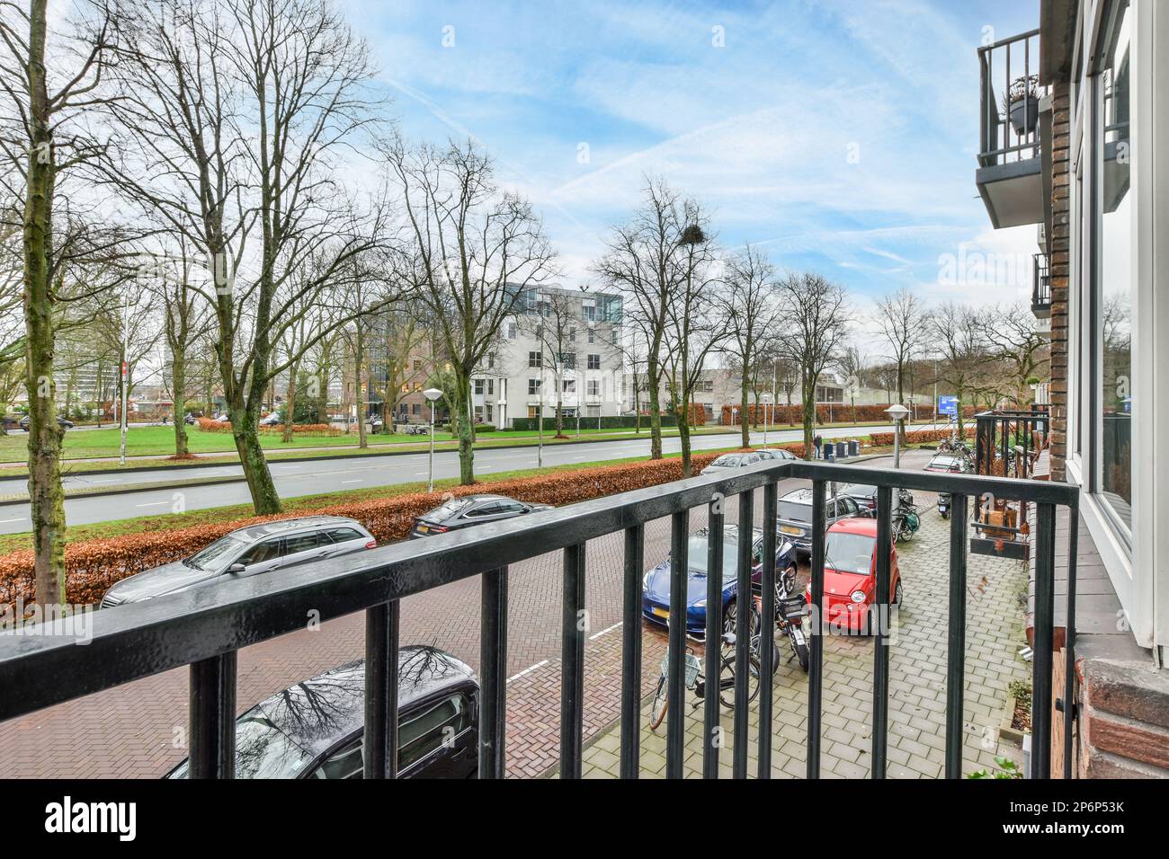 an outside area with cars parked on the sidewalk and trees in the ...