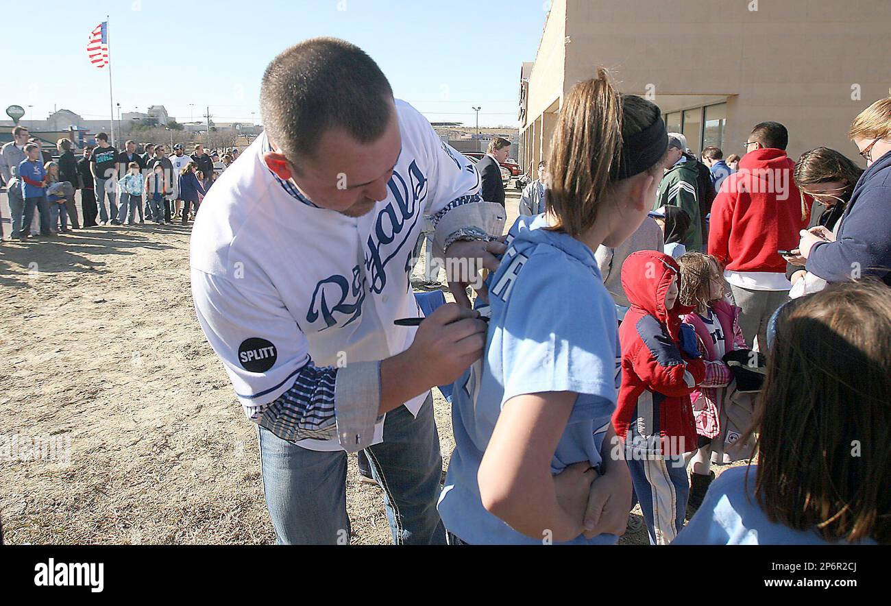 Kansas City Royals baseball player Billy Butler, left, signs the t-shirt of  13-year-old Torey Burkhardt, of Silver Lake, during the Royals caravan  Monday, Jan. 16, 2012 in Topeka, Kan. (AP Photo, Topeka