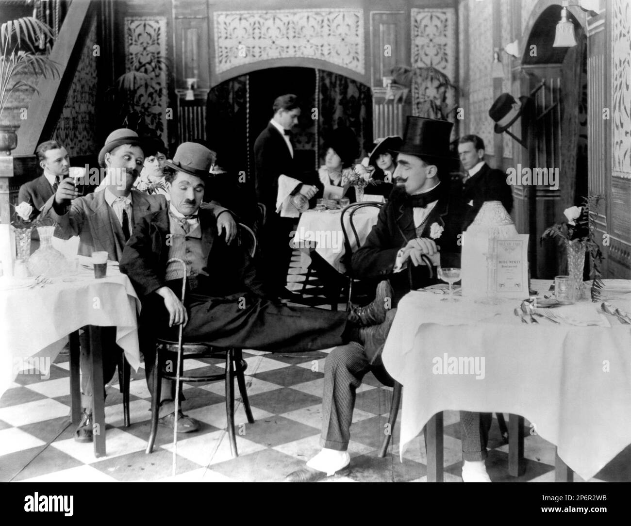 1915 : The silent movie actor and movie director CHARLES CHAPLIN ( 1889 - 1977 ) in A NIGHT OUT  with BEN TURPIN - CINEMA MUTO  - FILM -  - portrait - ritratto - hat - cappello - regista cinematografico - attore - ubriaco - drunk - comico - tie - cravatta  ---- Archivio GBB      Archivio Stock Photo