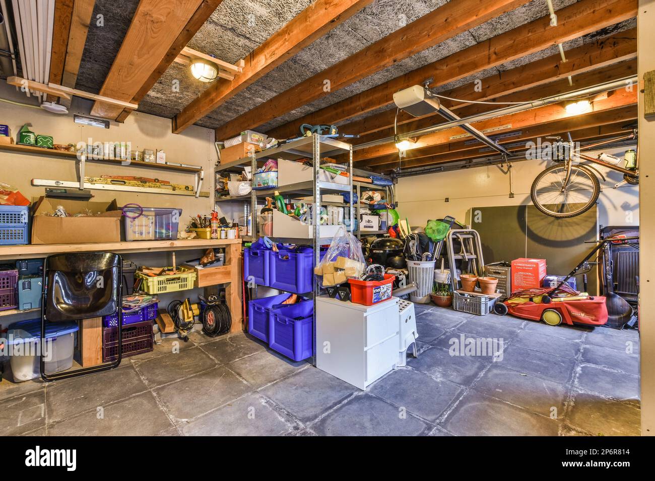 Amsterdam, Netherlands - 10 April, 2021: the inside of a garage with tools and boxes on the floor to be used for work or other things that are not in use Stock Photo