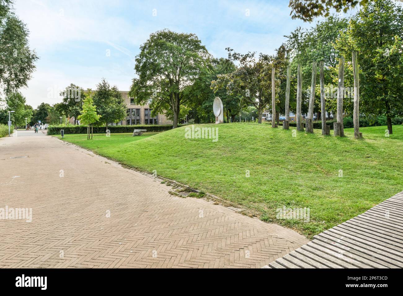 Amsterdam, Netherlands - 10 April, 2021: a park with some trees and grass on the ground in the background is a blue sky that has white clouds Stock Photo