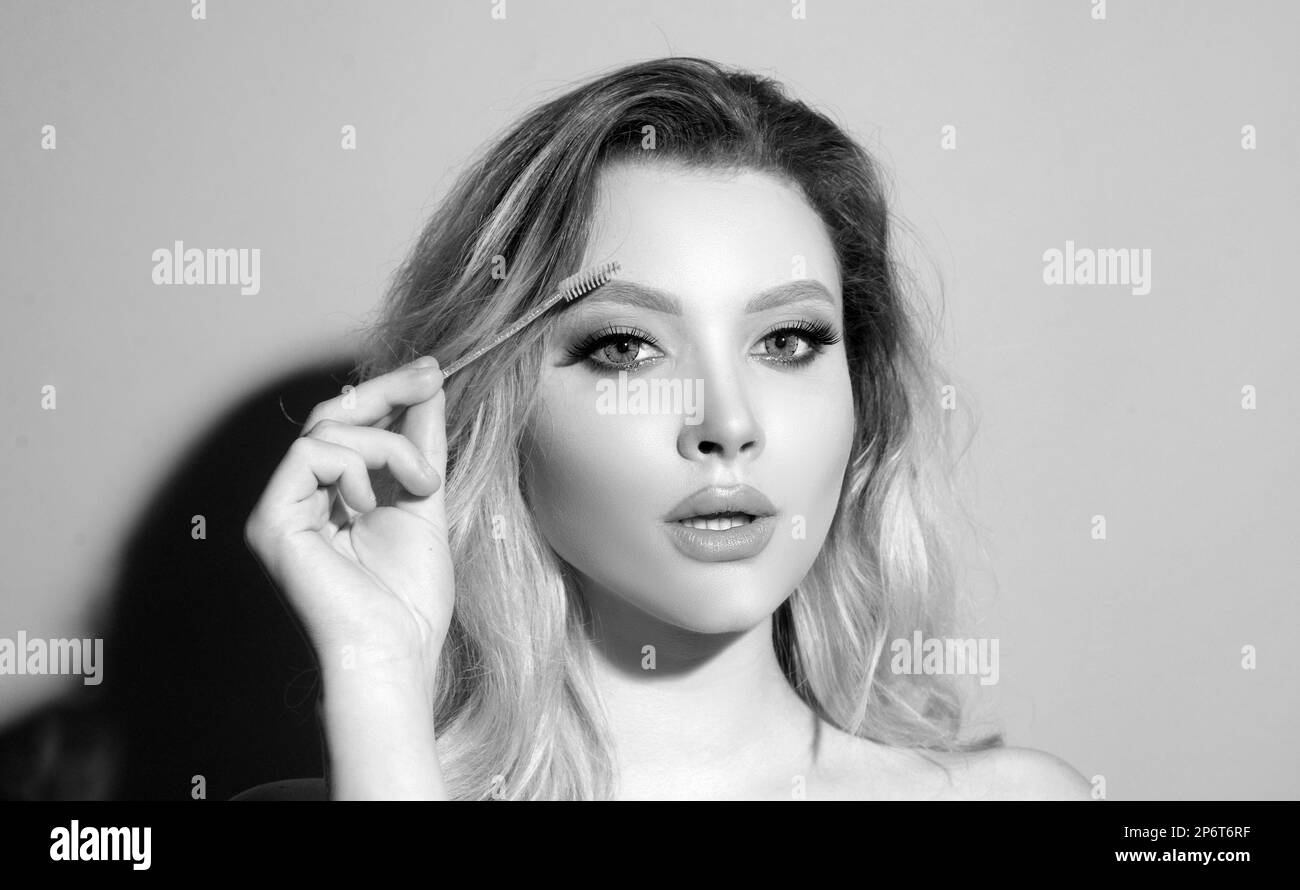 Beautiful female eye with perfect shape eyebrows. Beautiful girl with eyebrow brush. Eyebrow