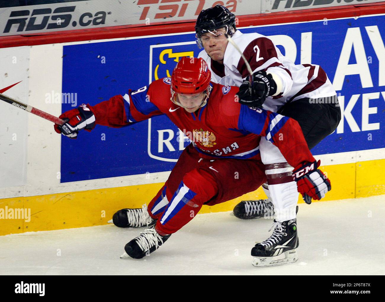 Latvias Kristaps Nimanis checks Russias Nikita Kucherov during the first period of a world junior hockey championships game in Calgary, Alberta, Thursday, Dec