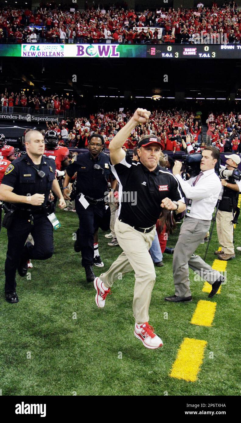 LouisianaLafayette head coach Mark Hudspeth leads his team onto the