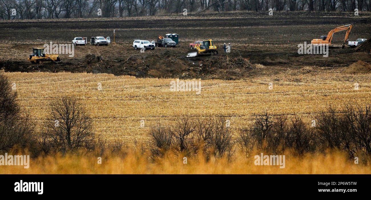 Work continues in a field contaminated by an oil spill near Nemaha