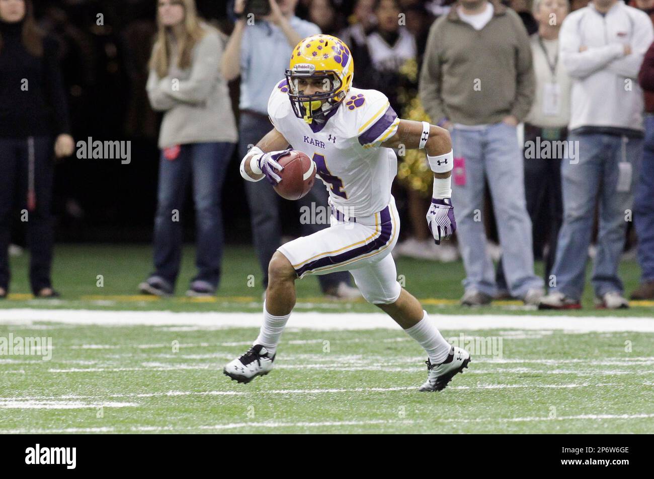 Edna Karr High School cornerback Noel Ellis (4) runs with an pass  interception against Neville High School in the first half of his Louisiana  state high school football championship game in New