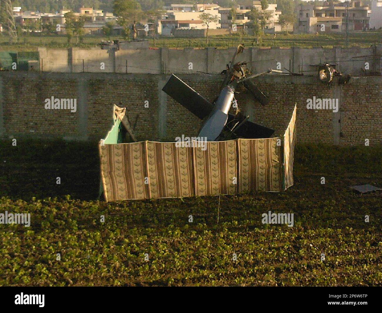 FOR USE AS DESIRED, YEAR END PHOTOS - FILE -This May 2, 2011 file photo,  taken by a local resident, shows the wreckage of a helicopter next to the  wall of the, image size:1300x1065