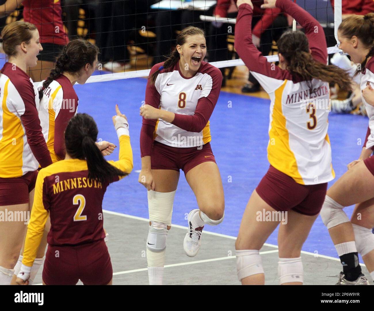 Minnesota players, including Katherine Harms (8), celebrate after winning a point during an NCAA college volleyball game against Iowa State in Minneapolis, Friday, Dec