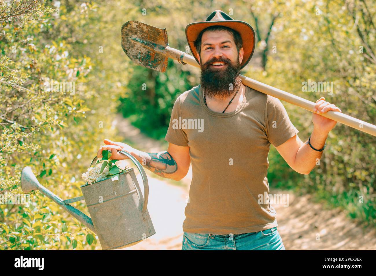 Funny Farmer with Shovel and watering can Stock Photo - Alamy