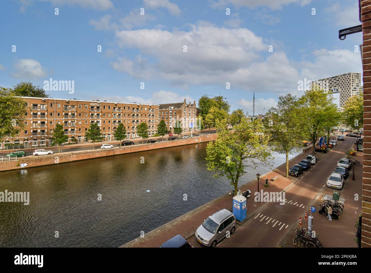 Amsterdam, Netherlands - 10 April, 2021: a river with cars parked on ...