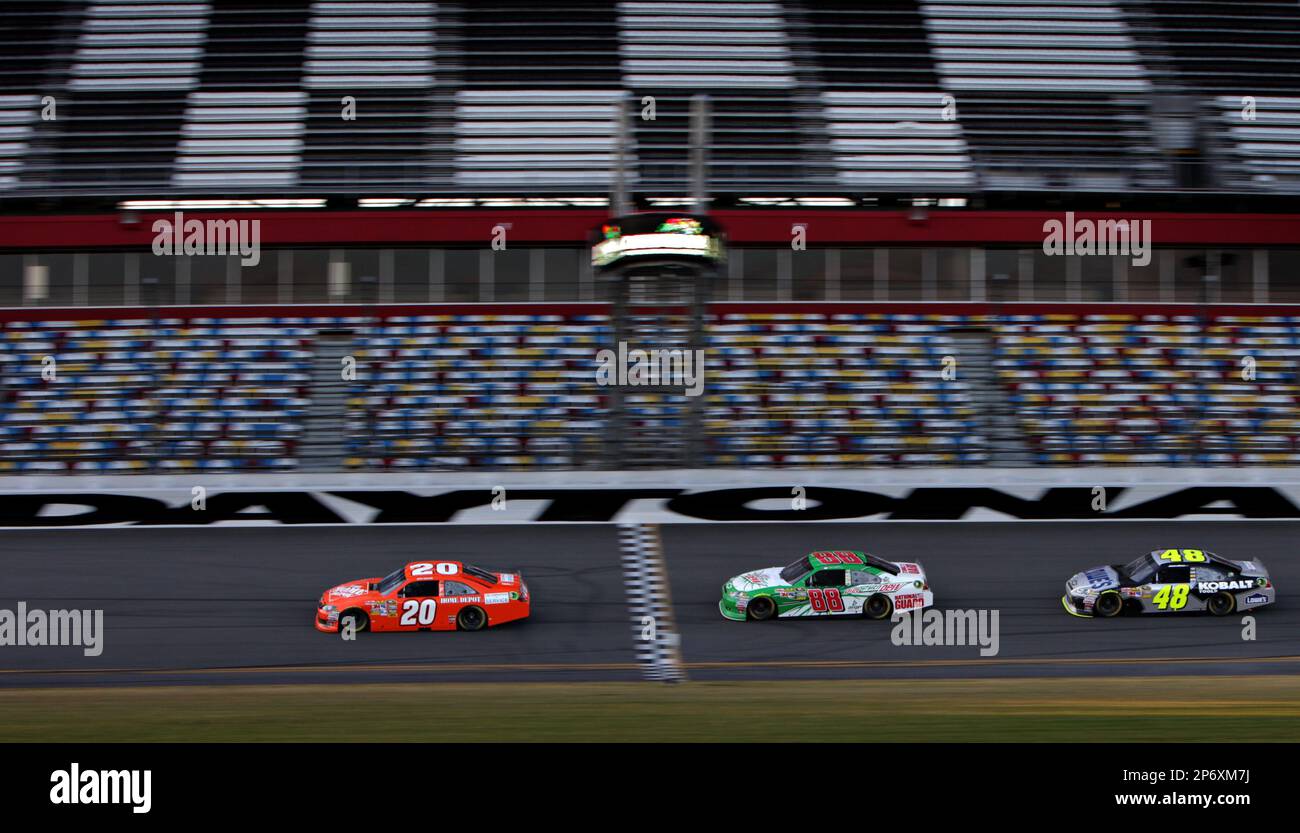 Joey Logano, Dale Earnhardt Jr. and Aric Almirola, from left, streak through the trioval at