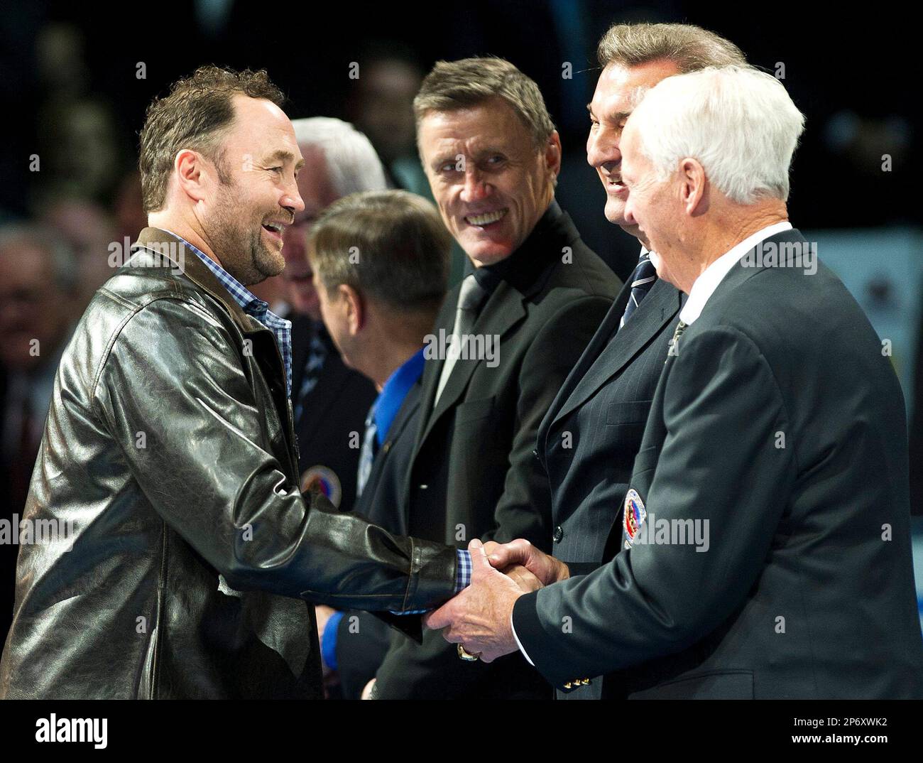 Hall of Fame inductee Ed Belfour, left, shakes hands with Gordie Howe