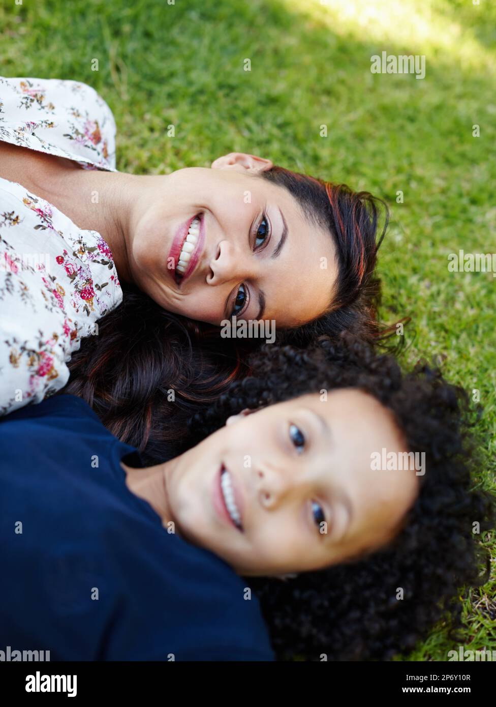 Moms my best friend. A young mother and her son lying on the grass in the  garden Stock Photo - Alamy