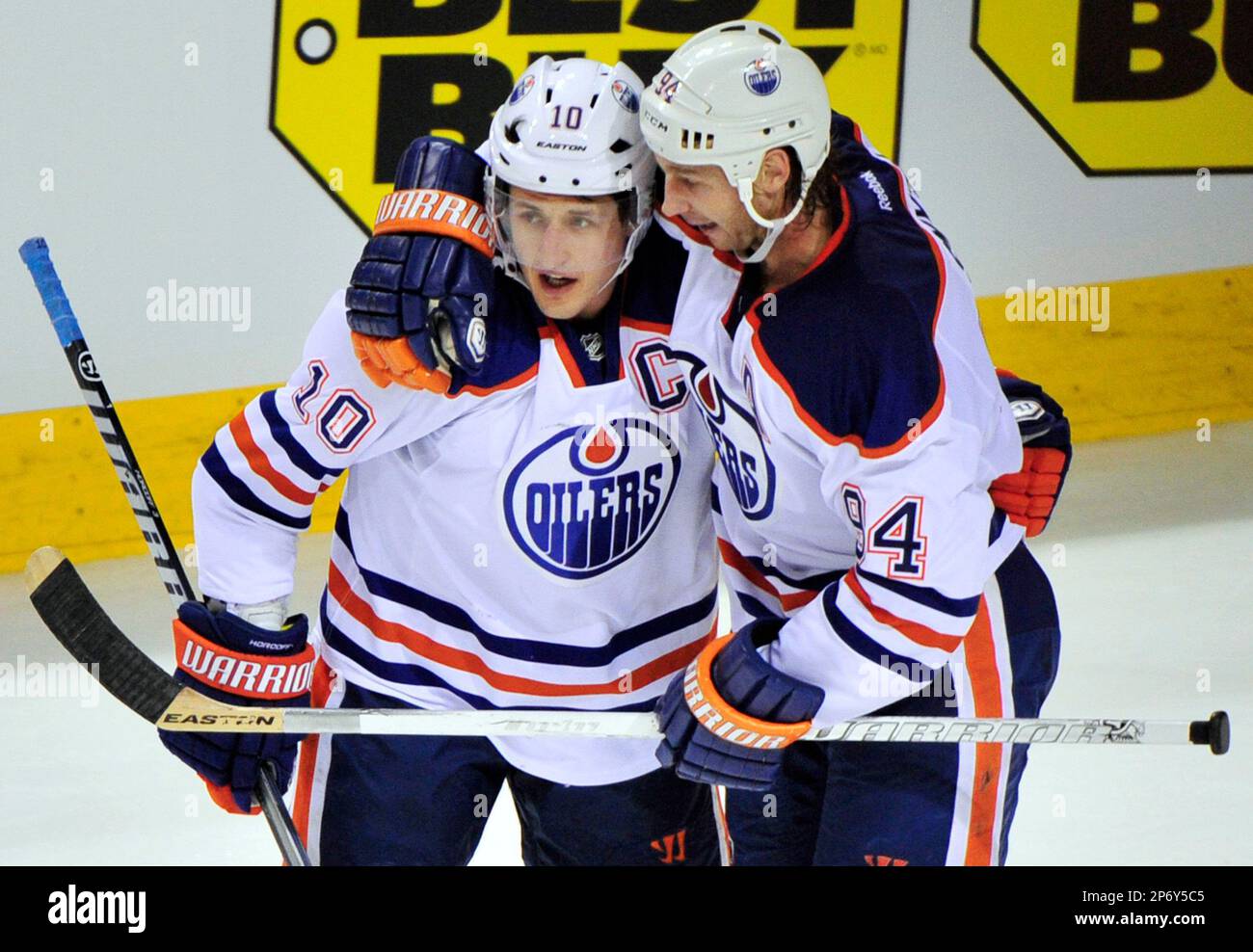 Edmonton Oilers Ryan Smyth, upper, is congratulated by Shawn Horcoff (10)  after Smyth scored past San Jose Sharks goalie Vesa Toskala, right, of  Finland, and Josh Gorges, left, in the third period