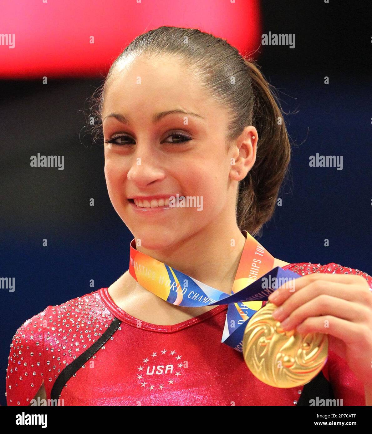 Jordyn Wieber of USA shows her gold medal on the podium during the women's individual all-round