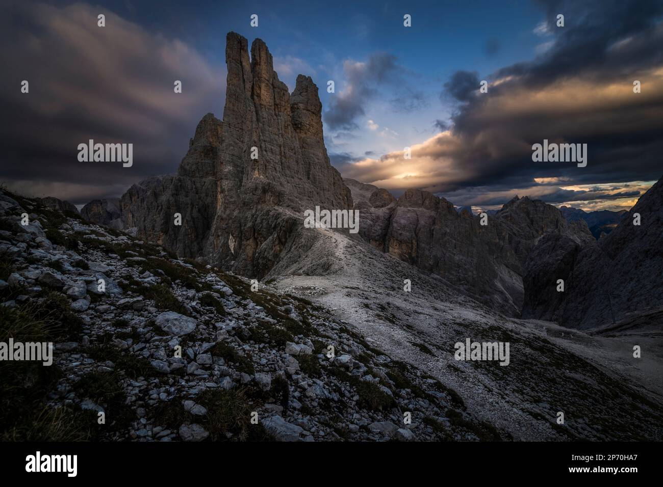 Picture of the Torri del Vajolet mountain range in Trentino, Italy at sunset over a cloudy sky Stock Photo