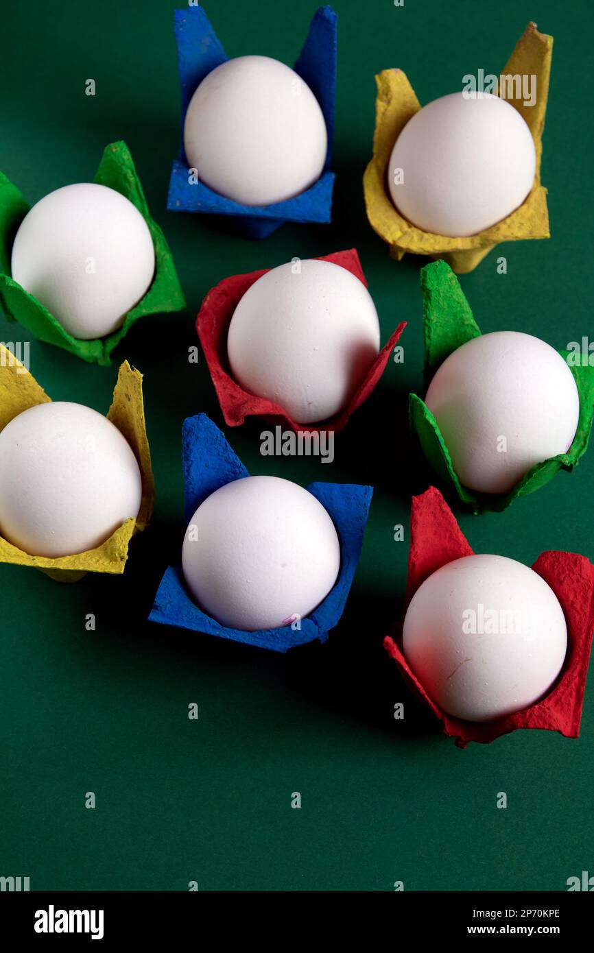 photo a lot of chicken eggs in colored cells standing side by side