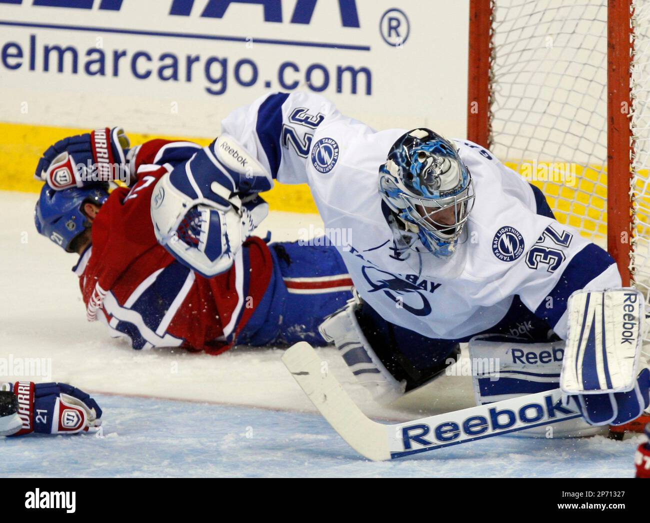 Montreal Canadiens' Brian Gionta, left, holds his head after colliding