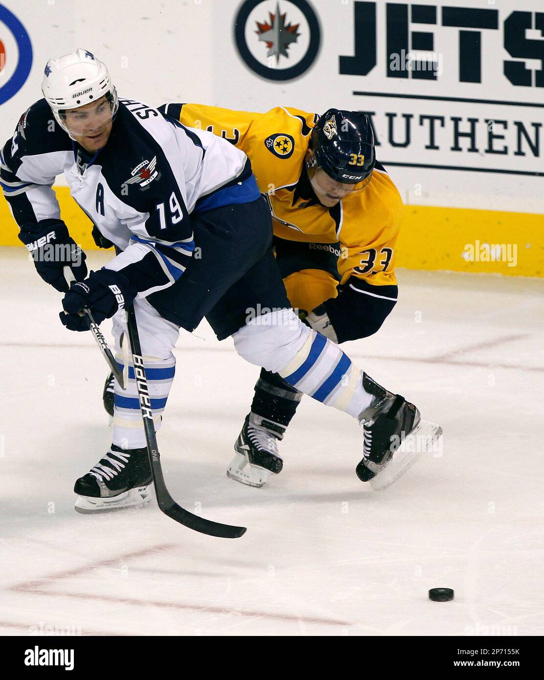 Winnipeg Jets Jim Slater, left, and Nashville Predators Colin Wilson collide during the first period of an NHL preseason hockey game against the Winnipeg Jets in Winnipeg, Manitoba, on Friday, Sept