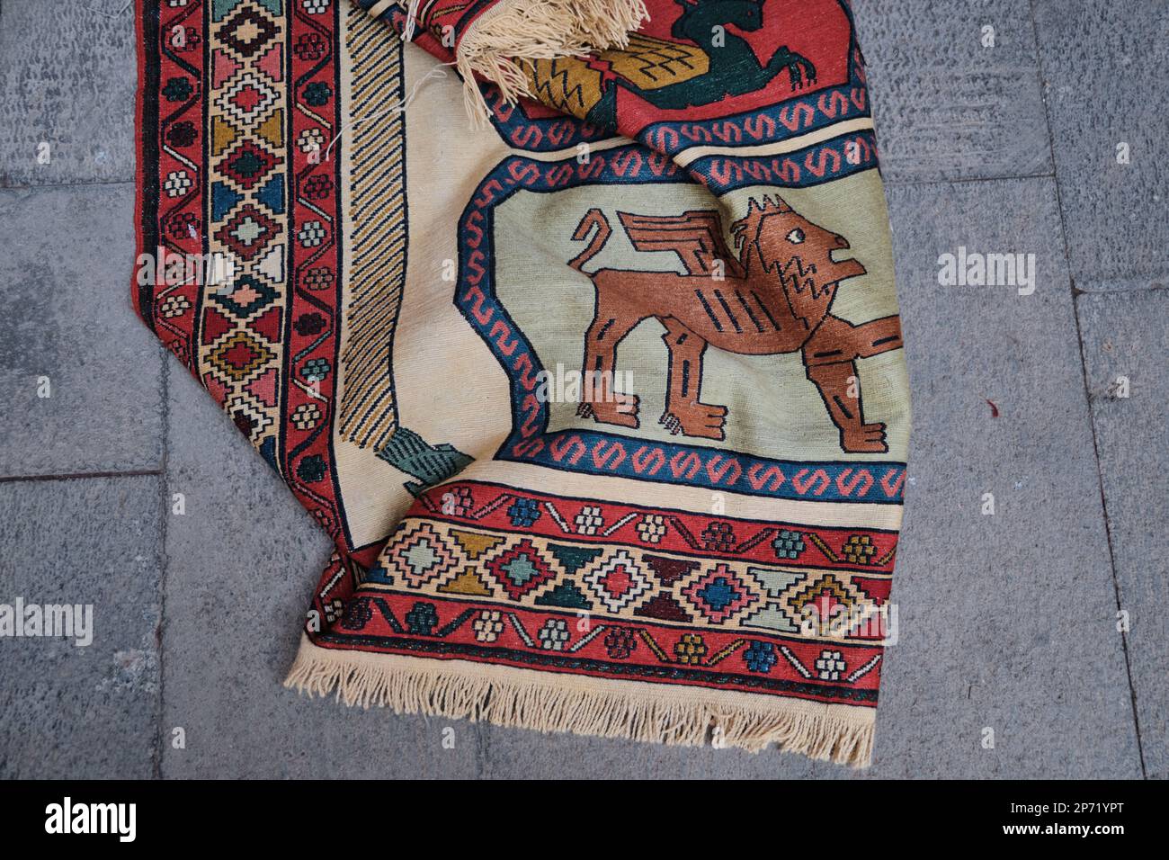 Top view of a Vintage handmade Persian rug- carpet with historical design on the ground. Stock Photo