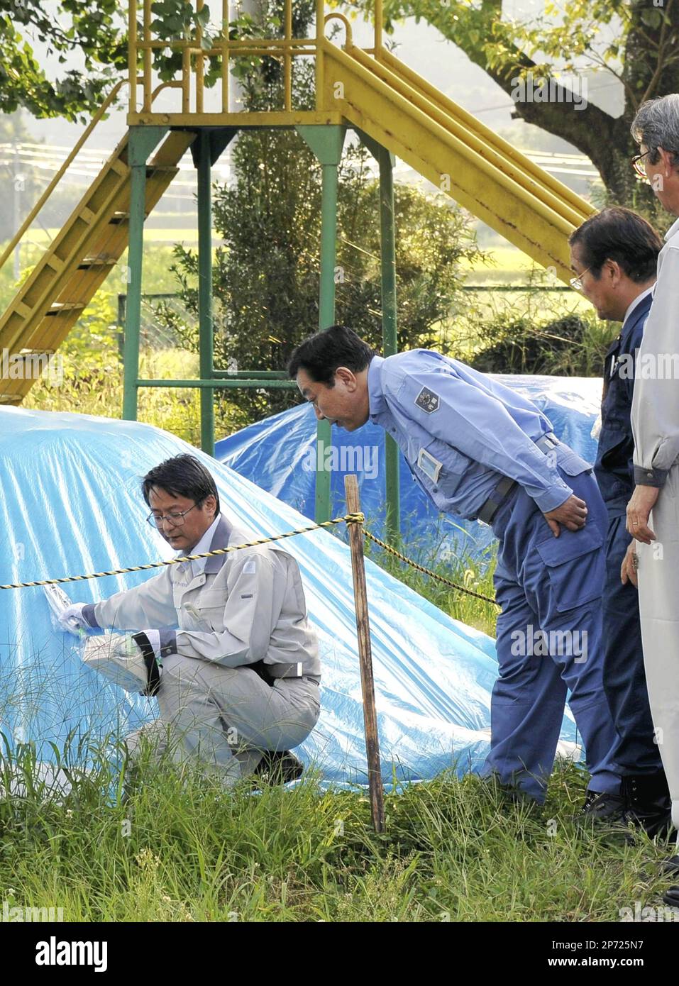 Japanese Prime Minister Yoshihiko Noda 3rd from R ) inspects the