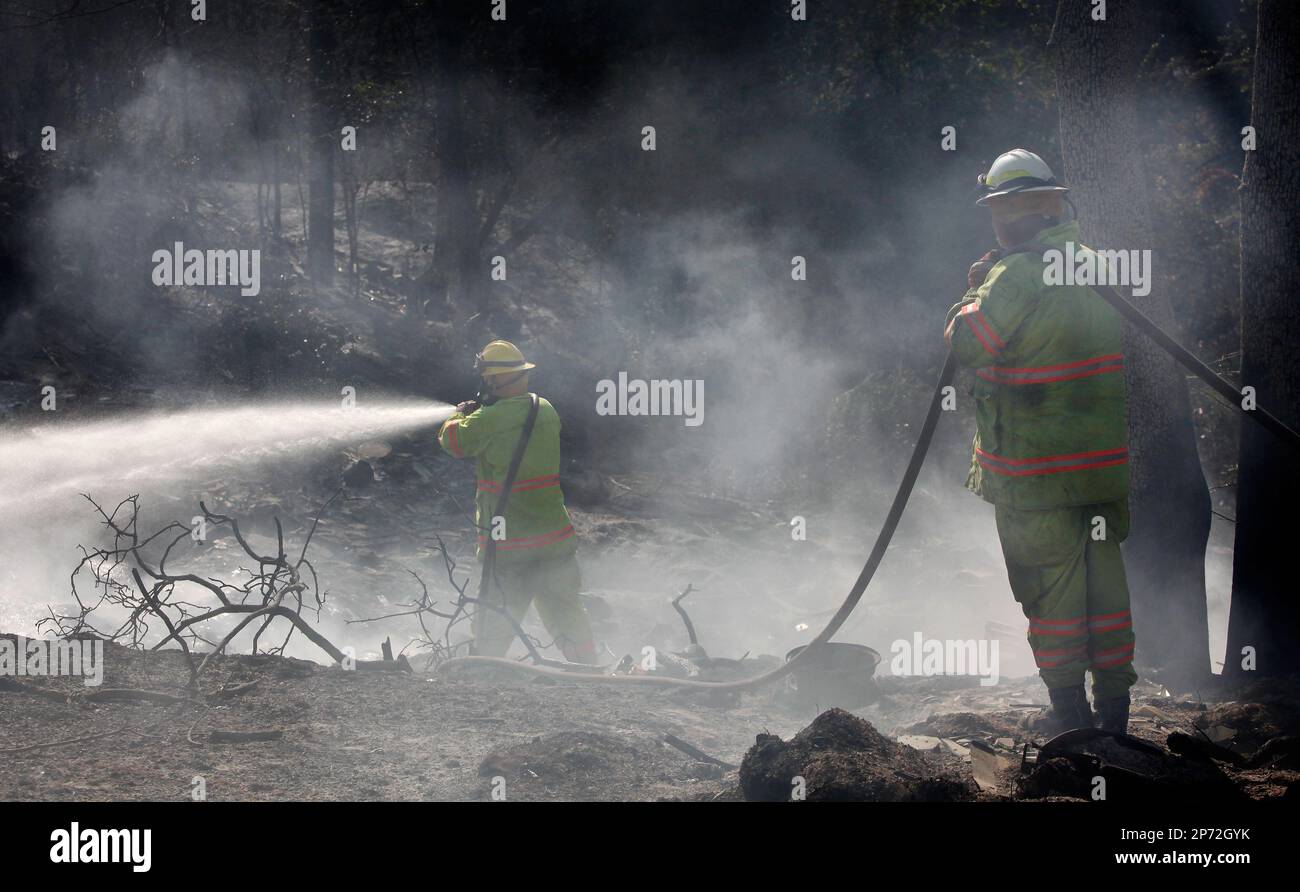 Two Tuttle, Oklahoma firefighters assist in controlling hot spots on