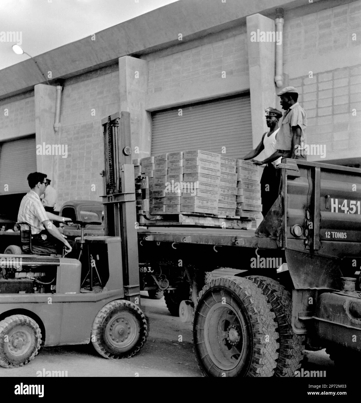 A forklift operator loads boxes onto a truck during the negotiations to