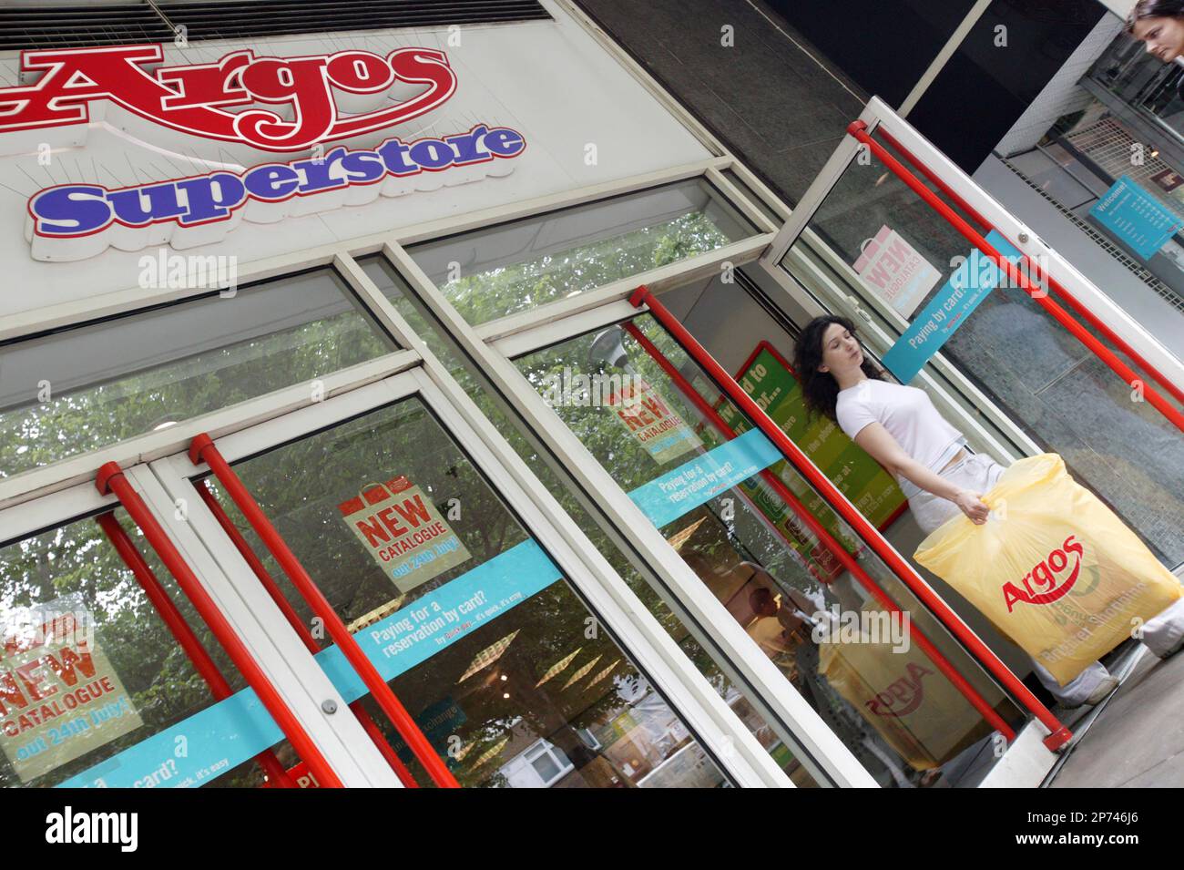 An Argos customer leaving a superstore with her purchase. Part of the