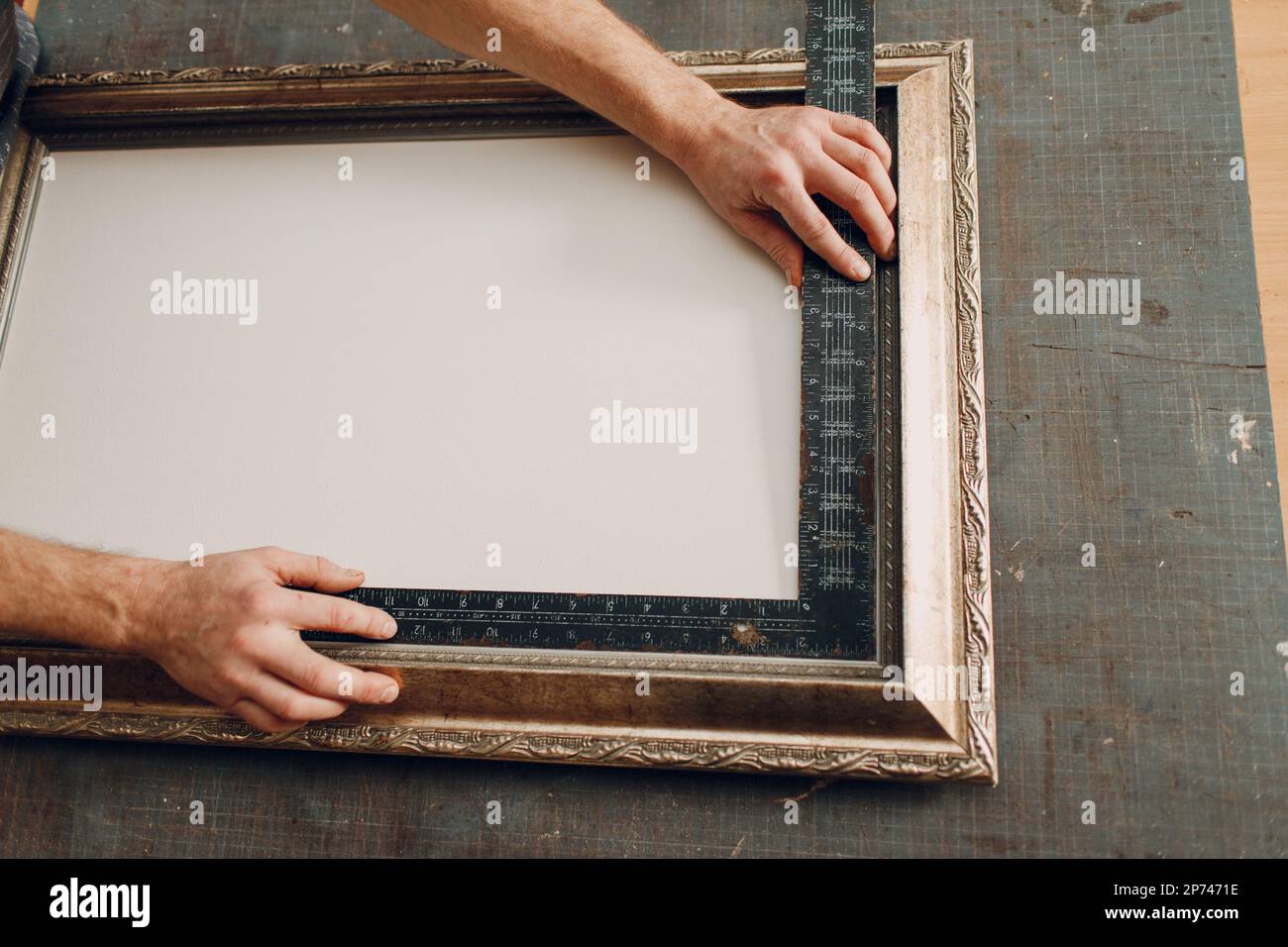Framing Workshop assembling. Stapler ruler and frames baguette handmade  picture frame at studio table Stock Photo - Alamy