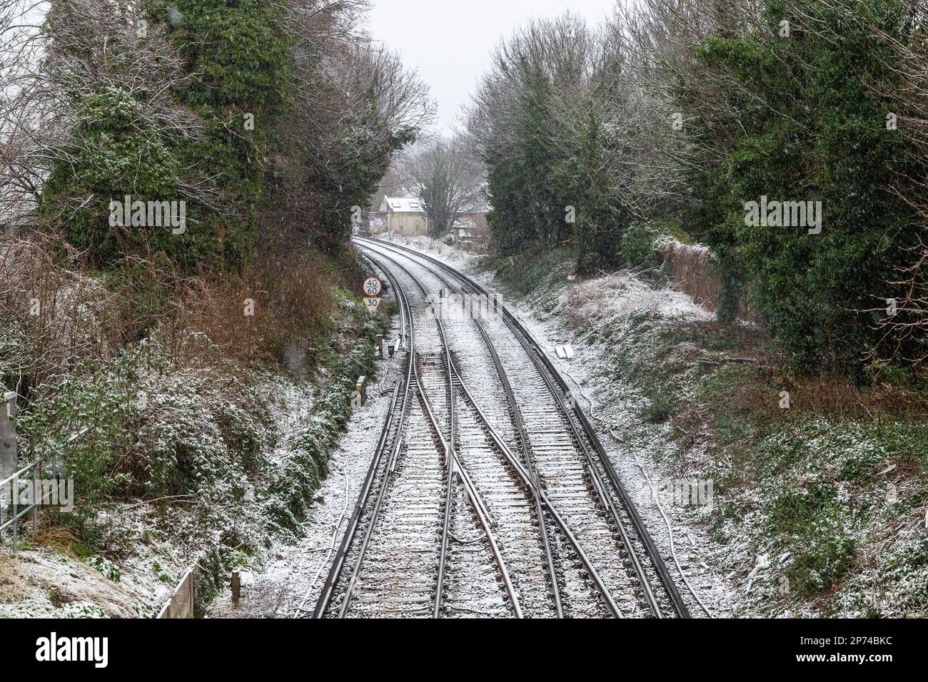 Railway tracks in London during a snowy winter day. Stock Photo
