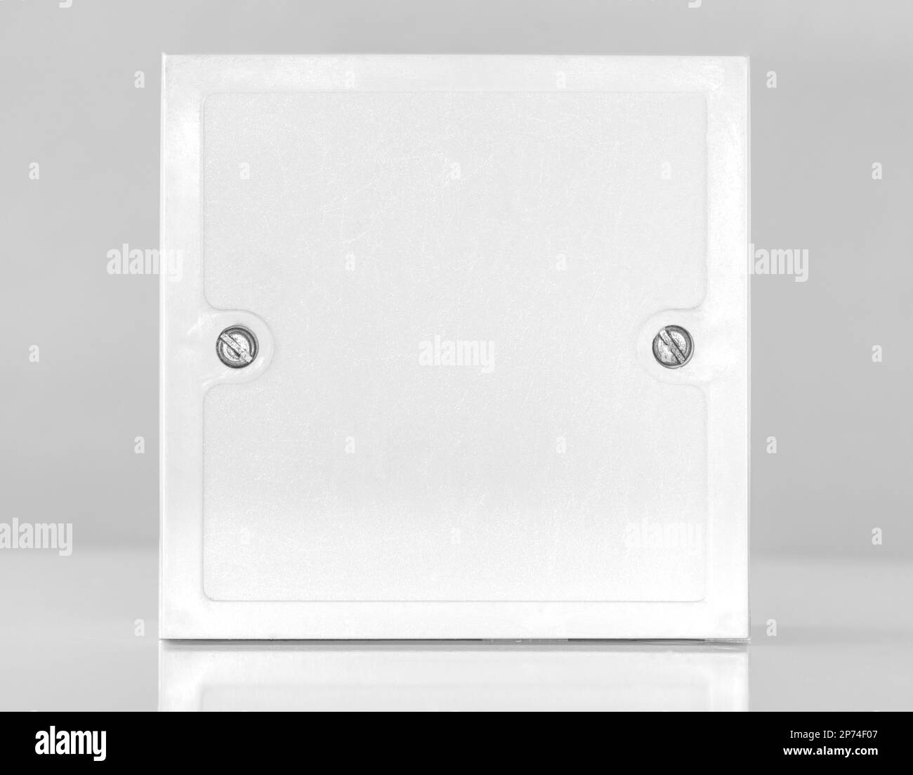 Small white square electrical junction box from the front view Stock Photo