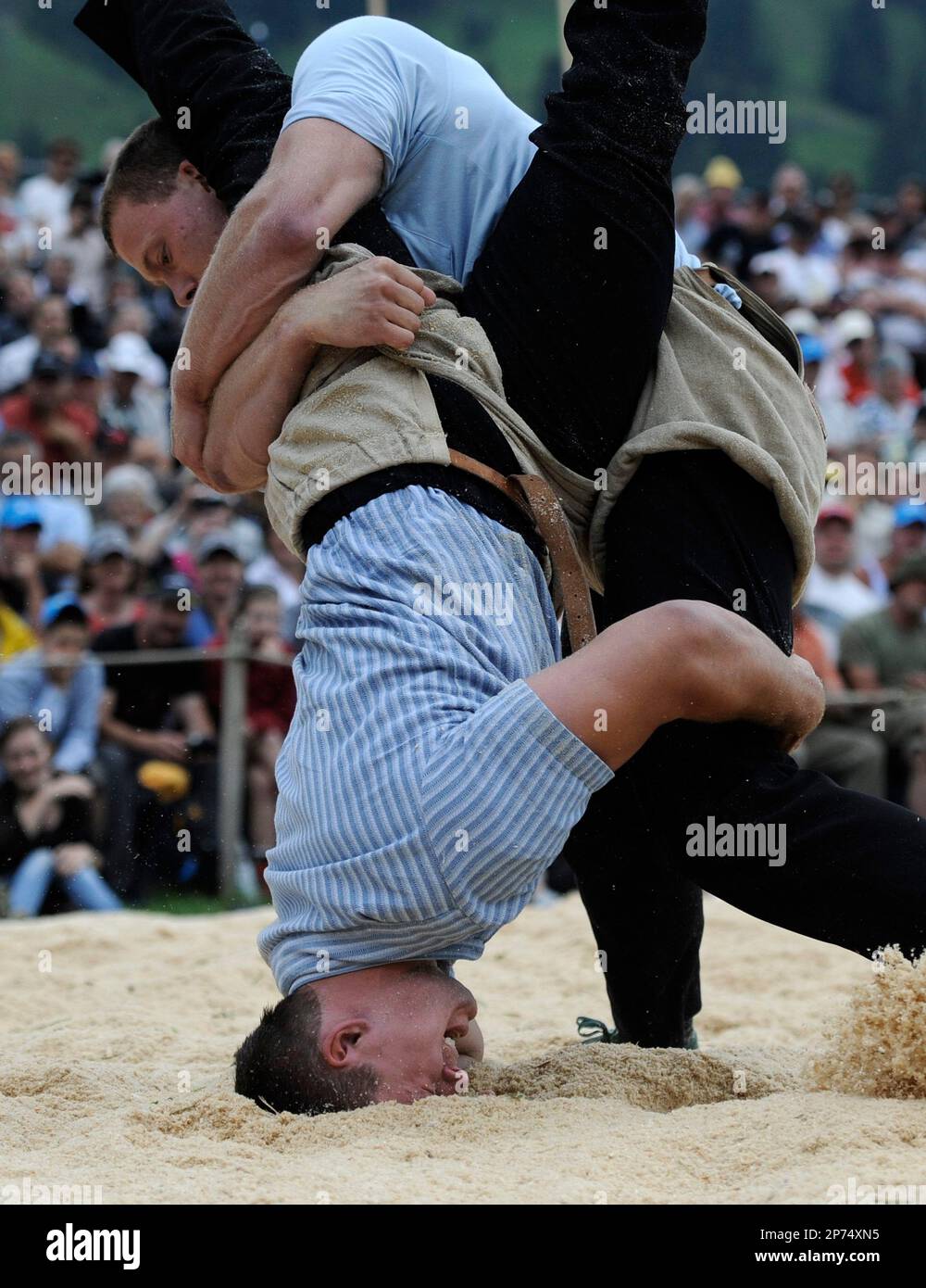Mathias Sempach, trop, wrestles reigning champion Kilian Wenger, bottom