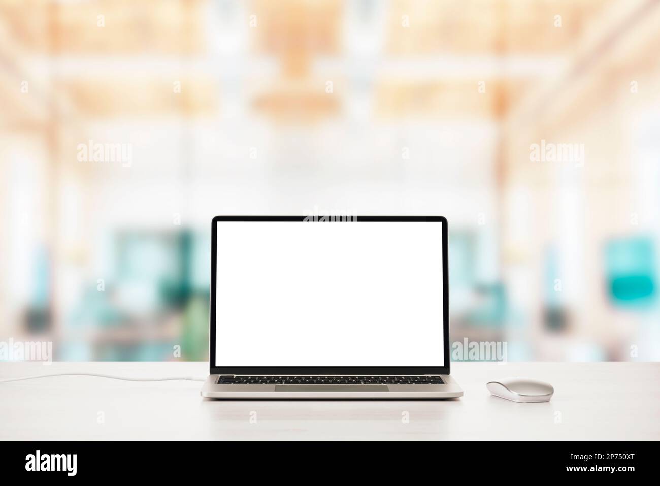 Modern laptop on office table with mouse with blank screen. Stock Photo