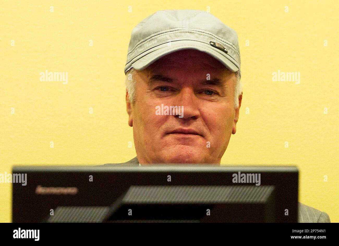 Former Bosnian Serb military chief Ratko Mladic sits in the court room during his further initial appearance at the U.N.'s Yugoslav war crimes tribunal in The Hague, Netherlands, Monday, July 4, 2011. Mladic has appeared in court at the Yugoslav war crimes tribunal to enter pleas to charges including genocide. The judge refused a request by Ratko Mladic's court-appointed lawyer to postpone initial plea. (AP Photo/ Valerie Kuypers, Pool) Stock Photo