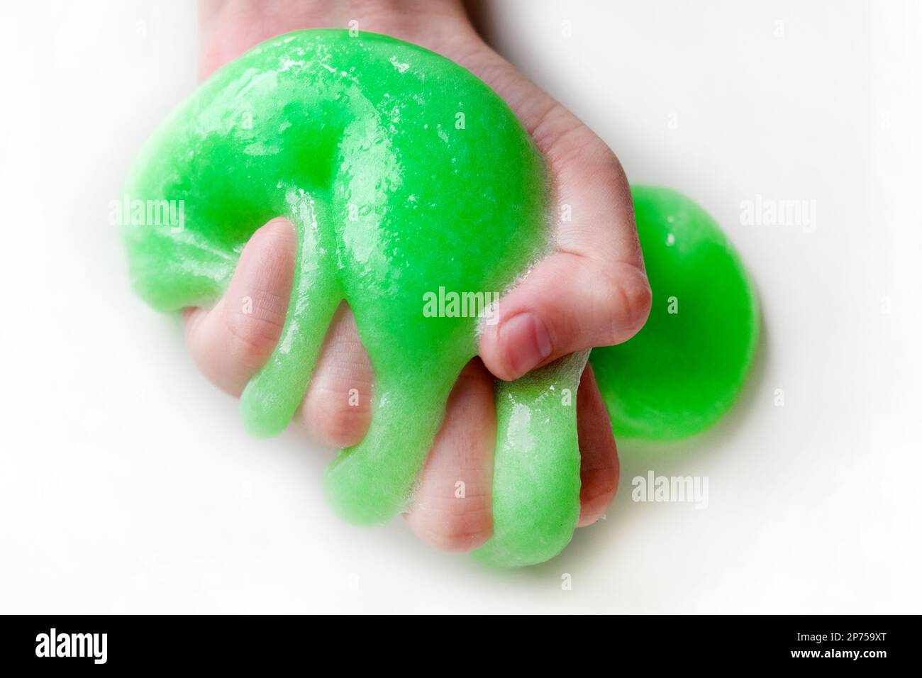 Hand Playing with textured slime with bubbles, stretching the gooey ...