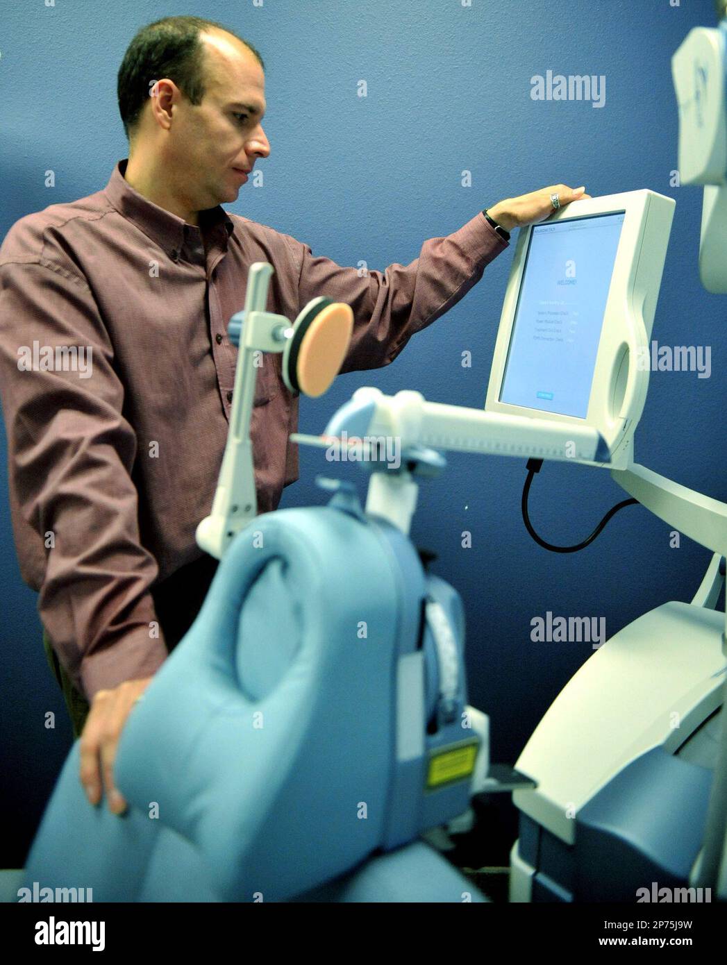In this June 1, 2011 photo, psychiatrist Dr. Scott Babe checks settings