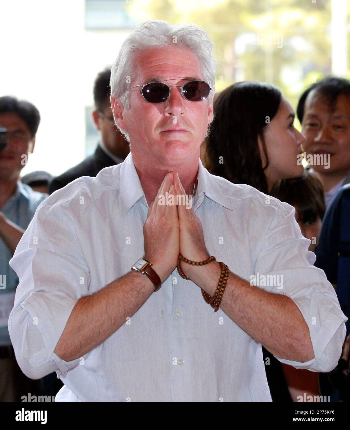 U.S. actor Richard Gere puts his hands together during his visit to the
