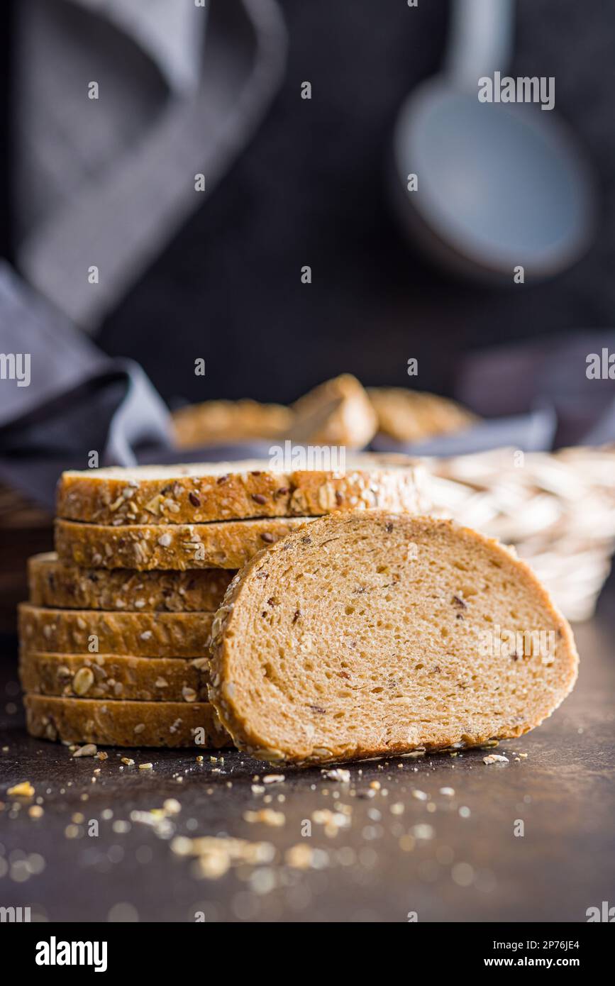 Sliced whole grain bread. Tasty wholegrain pastry with seeds on the ...