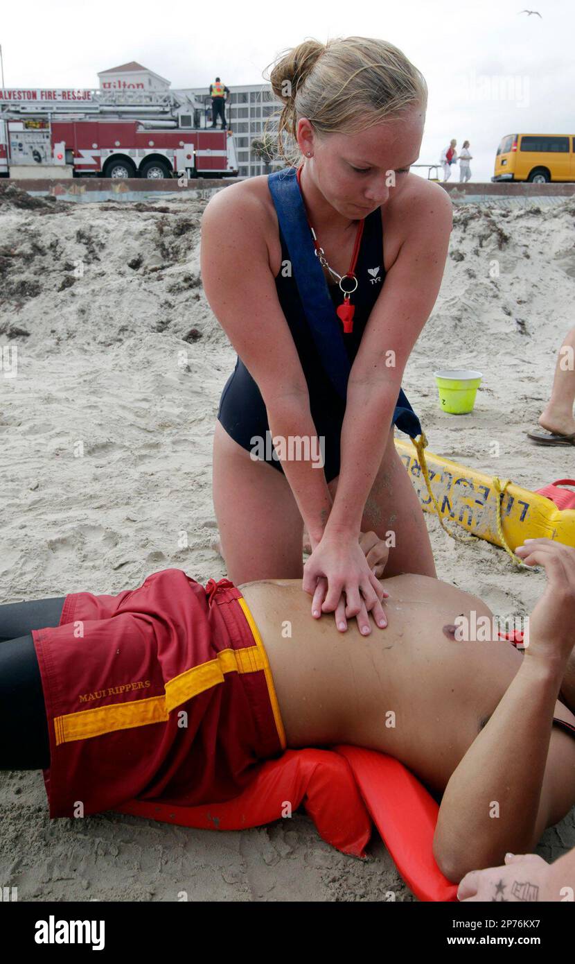 Galveston Island Beach Patrol lifeguard Kaitlyn Murrow simulates CPR on a  "victim" during the Galveston Marine Response Group's Mass Casualty Drill  on Wednesday evening May 18, 2011 on the beach at Seawall