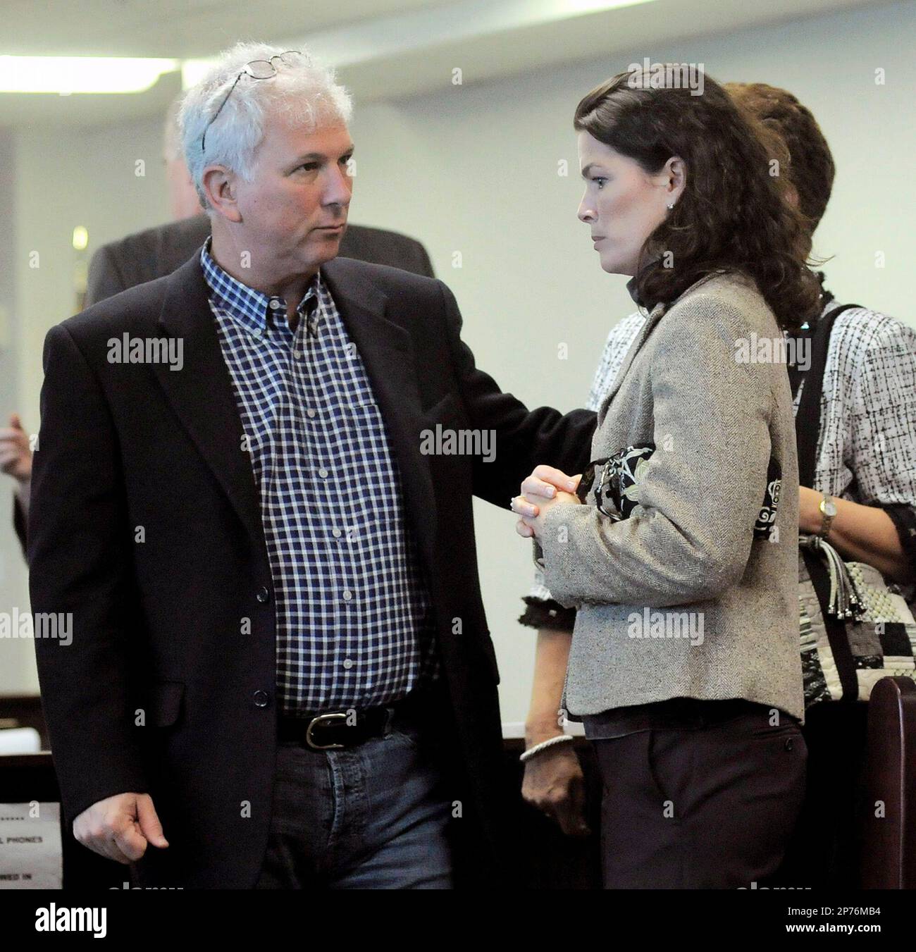 Jerry Solomon, left, appears in court with his wife, Olympic figure