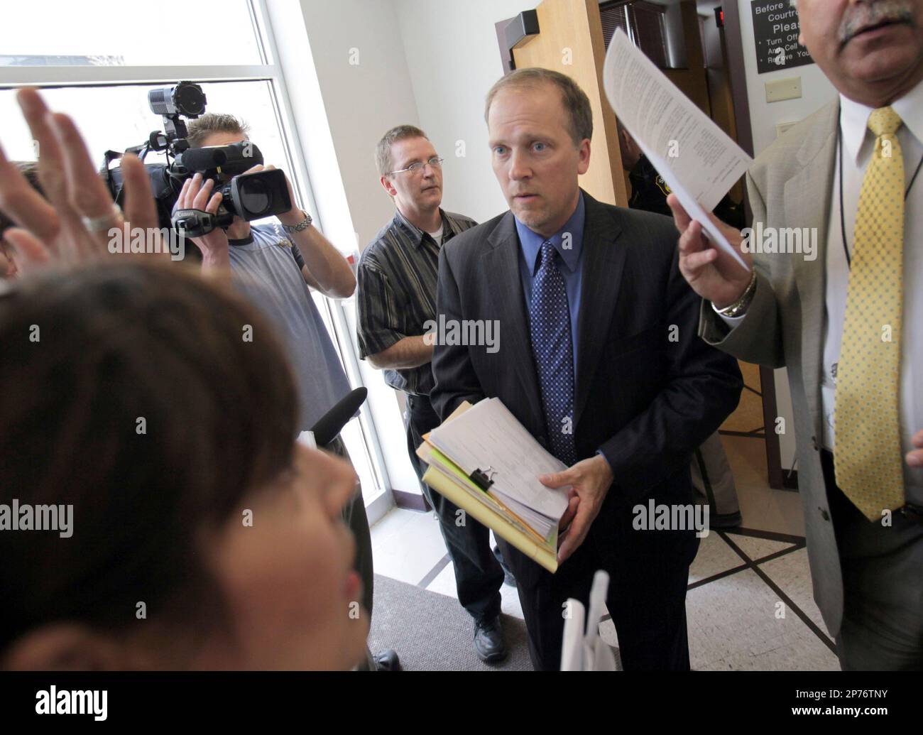 Waukesha County District attorney Brad Schimel, center, leaves the
