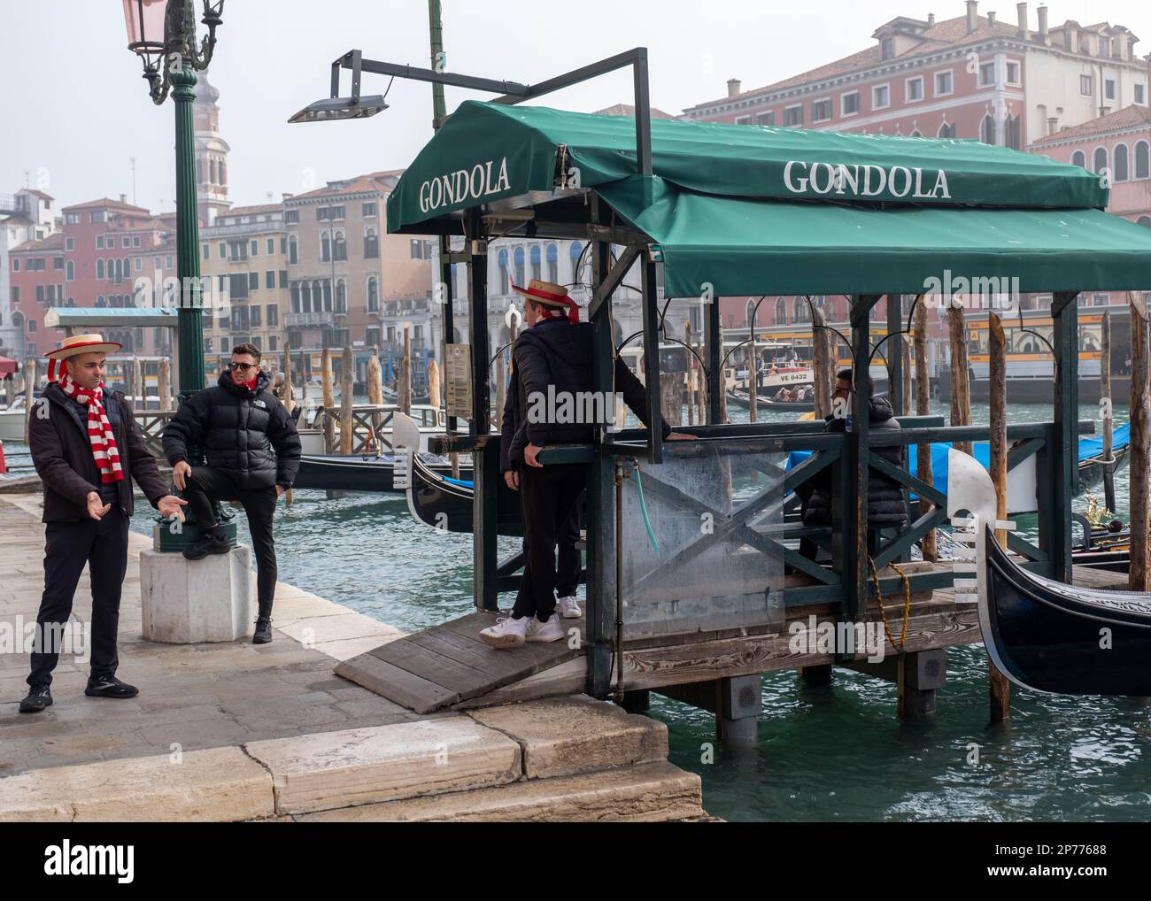 Gondoliers at San Silvestro chat before starting work on the Grand Canal, Venice, Italy. Stock Photo