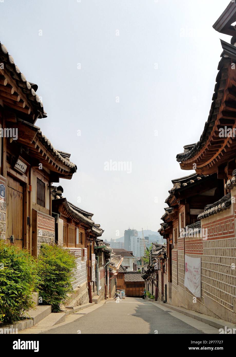 Seoul, South Korea - May 2022: Scenic old narrow street and traditional Korean architecture and houses of Bukchon Hanok Village with asian roof Stock Photo