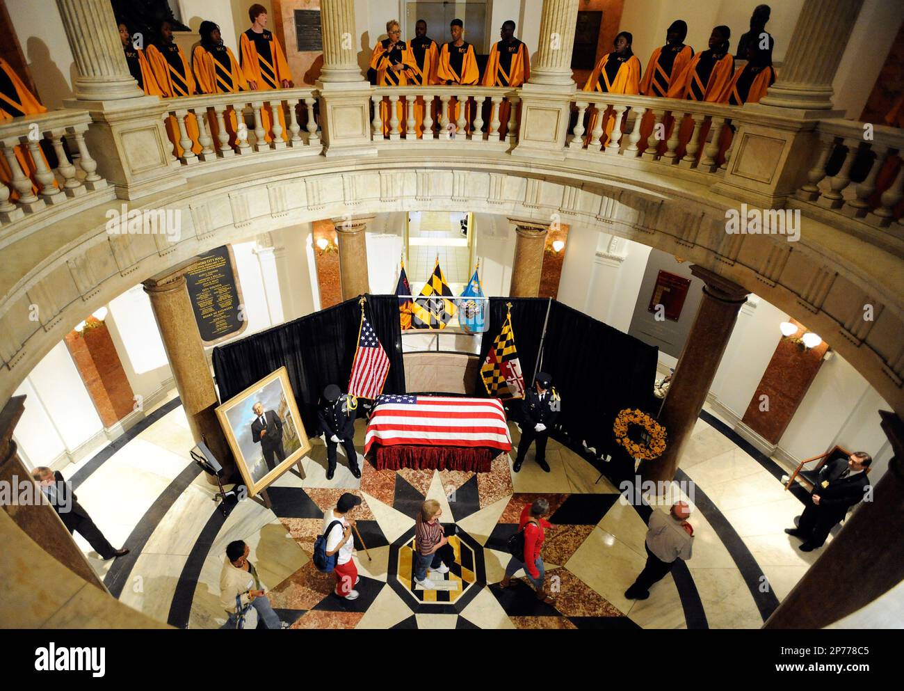 Members of the public visit the coffin of William Donald Schaefer, former Baltimore mayor and former Maryland governor and comptroller, as the Baltimore City College High School "Singing, Swingin' Knights" choir, top, performs at Baltimore City Hall, Tuesday, April 26, 2011, in Baltimore. Schaefer died April 18, at age 89. (AP Photo/Steve Ruark, Pool) Stock Photo