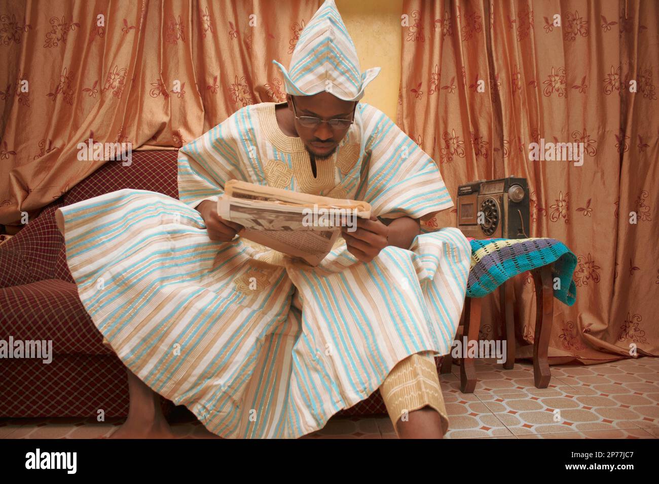 A Nigerian man in the olden days with the newspaper Stock Photo