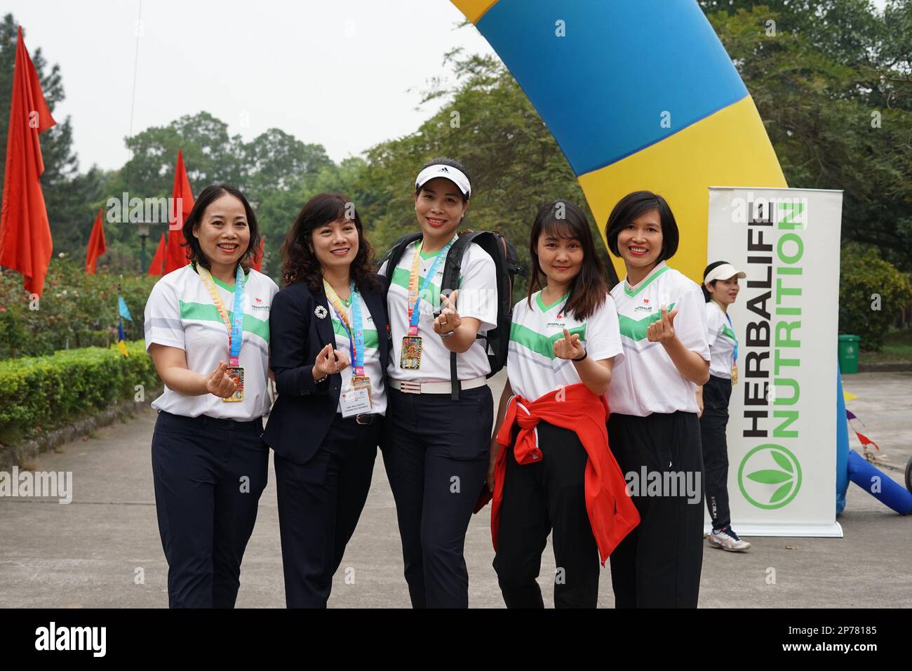 Bac Ninh. 8th Mar, 2023. Participants pose for photos after the