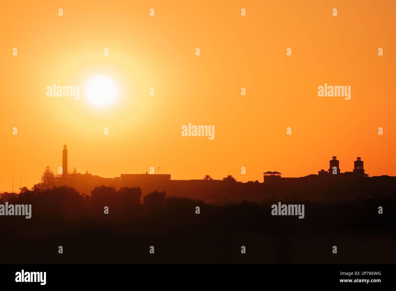 Townscape silhouette of Maspalomas in Gran Canaria with the lighthouse and a beautiful sunset Stock Photo